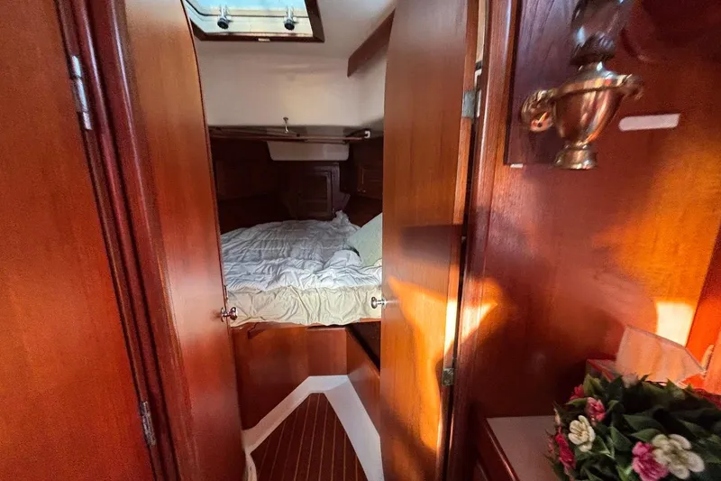 Slide: The Image of Cozy cabin interior of 1983 Bristol 38.8 sailboat with wooden finish and bed. - 10