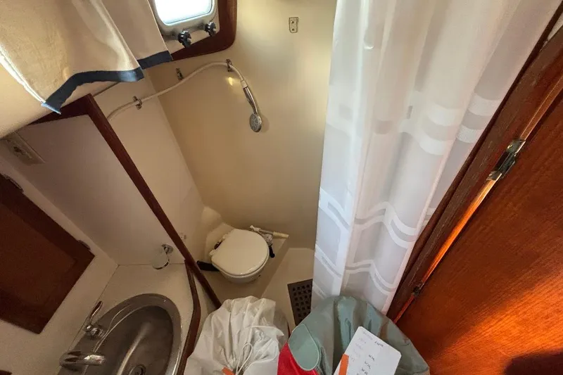 Slide: The Image of Compact bathroom in a 1983 Bristol 38.8 yacht with shower and sink. - 12
