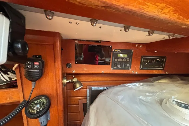 Slide: The Image of Interior of a 1983 Bristol 38.8 sailboat with navigation equipment and wooden paneling. - 18