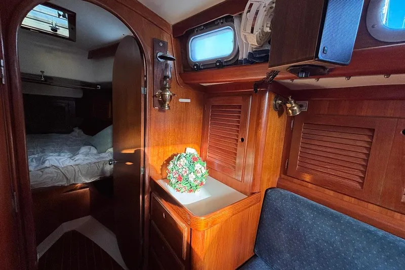 Slide: The Image of Interior of 1983 Bristol 38.8 yacht with wooden cabinetry and cozy sleeping area. - 9