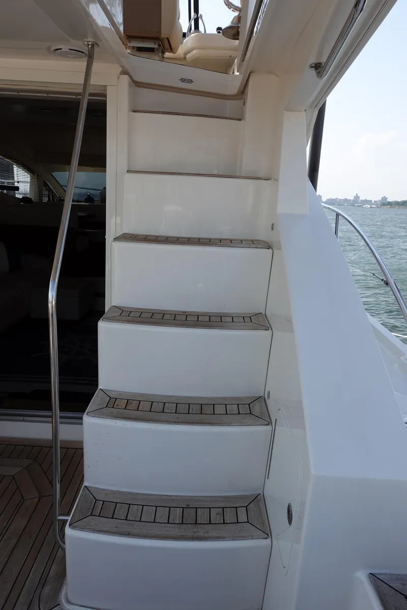 Slide: The Image of Luxurious interior of 2012 Sea Ray 450 Sedan Bridge with teak flooring and plush seating. - 10