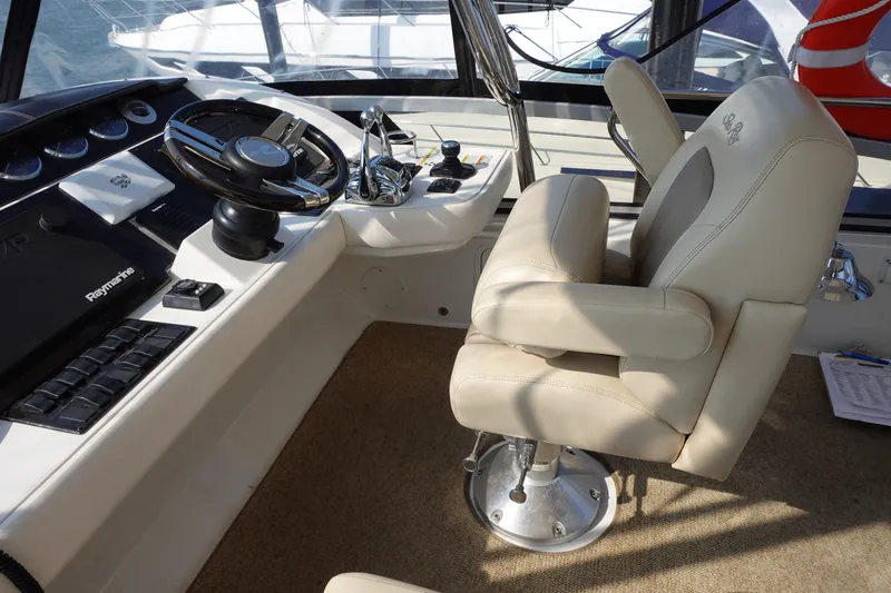 Slide: The Image of 2012 Sea Ray 450 Sedan Bridge yacht deck with sink, seating, and director's chair. - 12