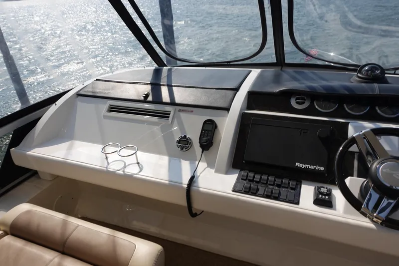 Slide: The Image of Cockpit of 2012 Sea Ray 450 Sedan Bridge with steering wheel and navigation controls. - 14