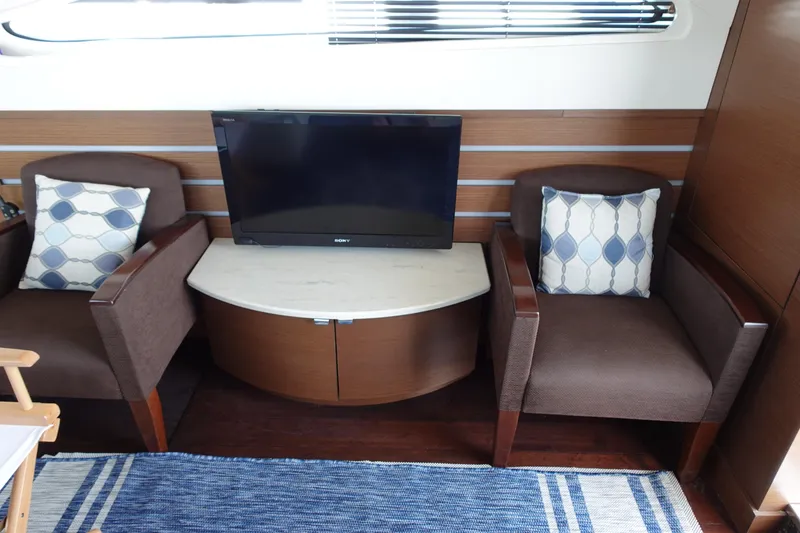 Slide: The Image of Luxurious interior of 2012 Sea Ray 450 Sedan Bridge yacht with seating and table. - 20
