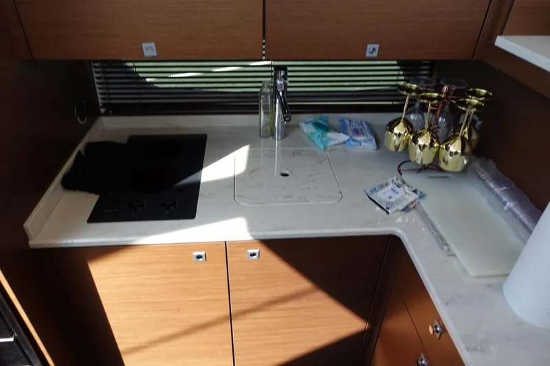 Slide: The Image of Luxurious white leather sofa on Sea Ray 450 Sedan Bridge, 2012, with nautical-themed decor. - 24