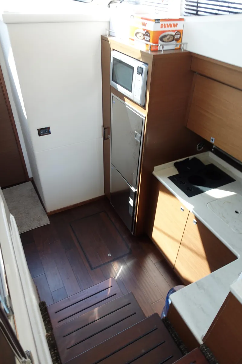 Slide: The Image of Interior of 2012 Sea Ray 450 Sedan Bridge yacht with modern seating and nautical decor. - 25