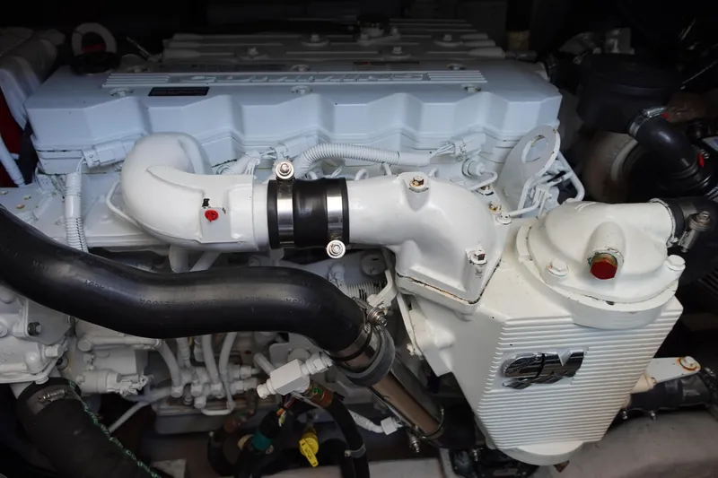 Slide: The Image of Cabin interior of 2012 Sea Ray 450 Sedan Bridge with twin beds and nautical-themed bedding. - 34