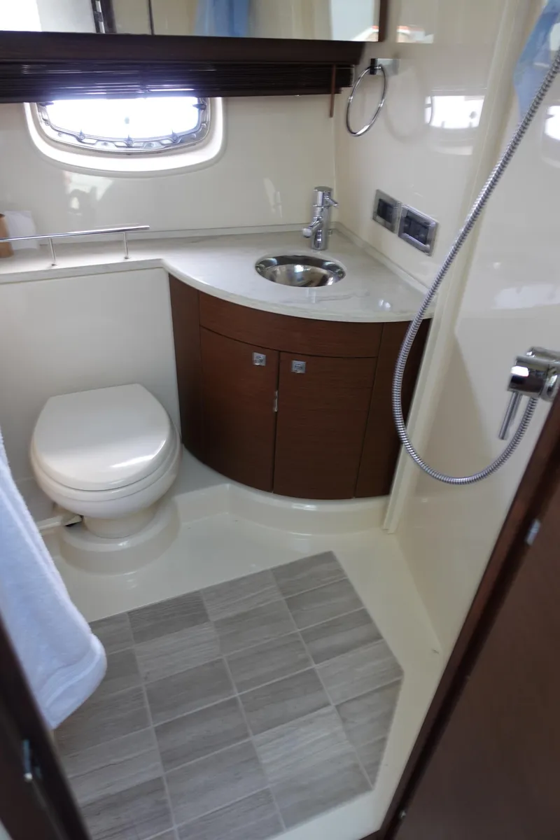 Slide: The Image of 2012 Sea Ray 450 Sedan Bridge bathroom with modern fixtures and compact design. - 37