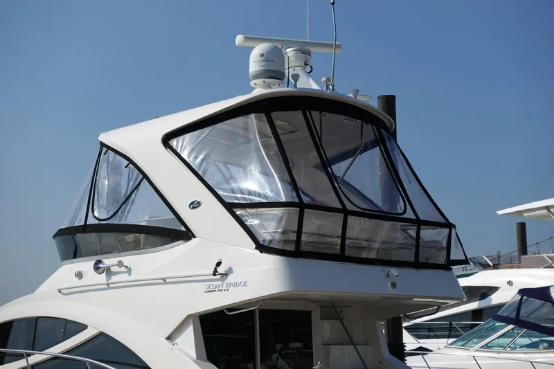 Slide: The Image of 2012 Sea Ray 450 Sedan Bridge yacht docked at marina with American flag. - 7