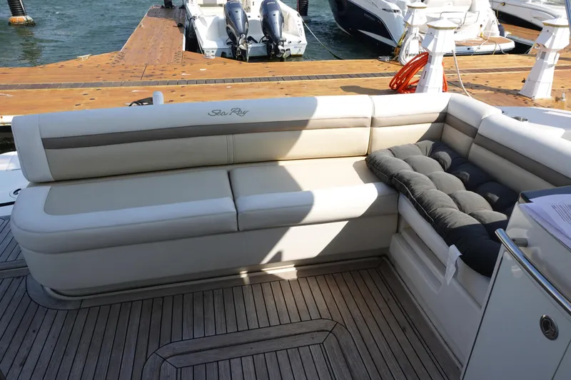 Slide: The Image of 2012 Sea Ray 450 Sedan Bridge yacht with enclosed flybridge, docked under clear blue sky. - 8