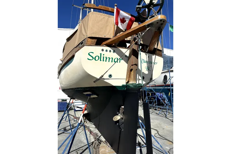 Slide: The Image of Sam L. Morse Bristol Channel Cutter 28 sailboat, 2000, docked with Canadian flag. - 12