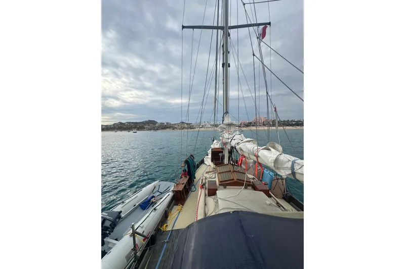 Slide: The Image of Sailing on a 2000 Sam L. Morse Bristol Channel Cutter 28 near coastal town. - 16