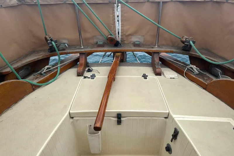 Slide: The Image of Cockpit of 2000 Sam L. Morse Bristol Channel Cutter 28 sailboat with wooden tiller and ropes. - 19