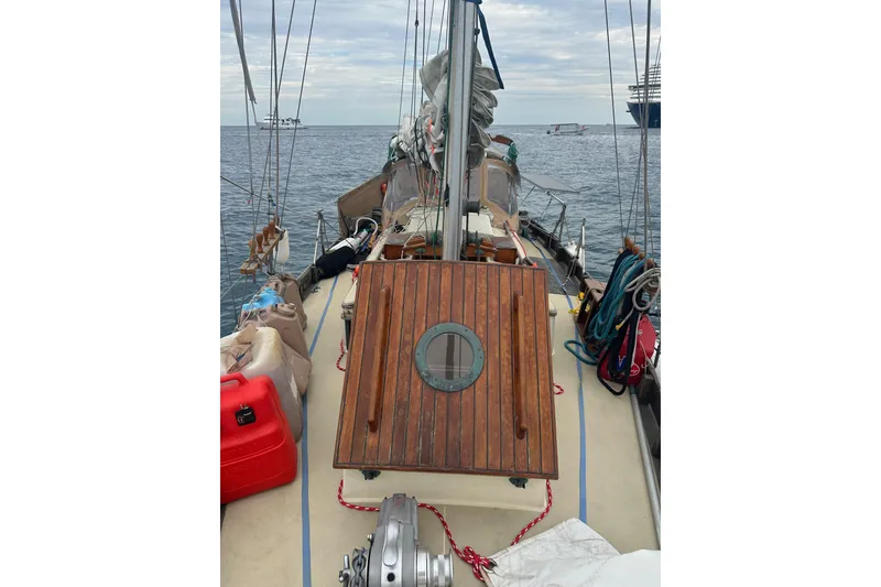 Slide: The Image of 2000 Sam L. Morse Bristol Channel Cutter 28 sailboat deck with wooden hatch and ocean view. - 21