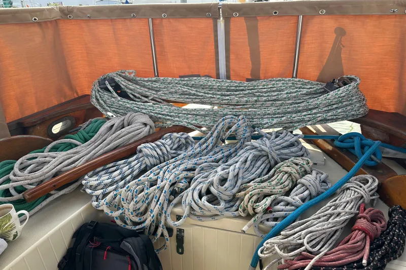 Slide: The Image of Coiled ropes on a 2000 Sam L. Morse Bristol Channel Cutter 28 sailboat deck. - 24