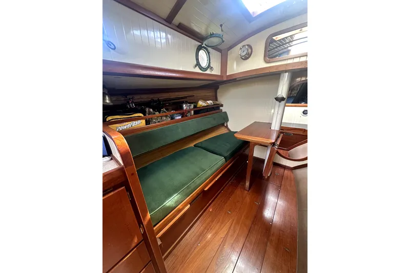 Slide: The Image of Interior of 2000 Sam L. Morse Bristol Channel Cutter 28 with green cushioned seating. - 4