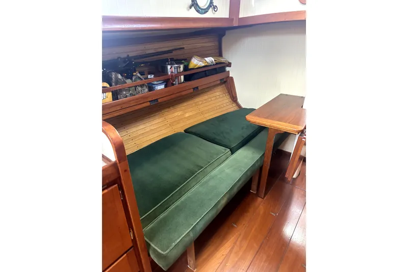 Slide: The Image of Interior of 2000 Sam L. Morse Bristol Channel Cutter 28 with green cushions and wooden table. - 5