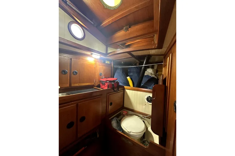 Slide: The Image of Interior of 2000 Sam L. Morse Bristol Channel Cutter 28, featuring wooden cabinetry and compact design. - 8