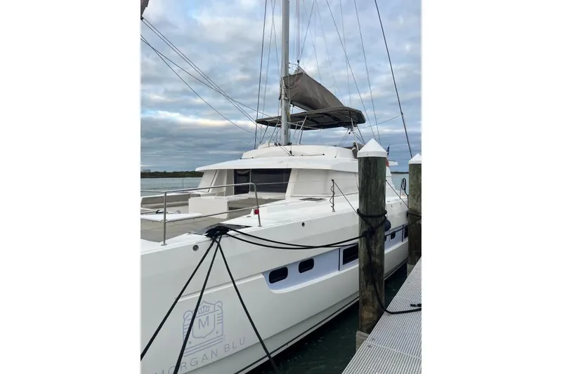 Slide: The Image of Luxury Bali 5.4 catamaran docked, 2021 model, with sleek design and spacious deck. - 4