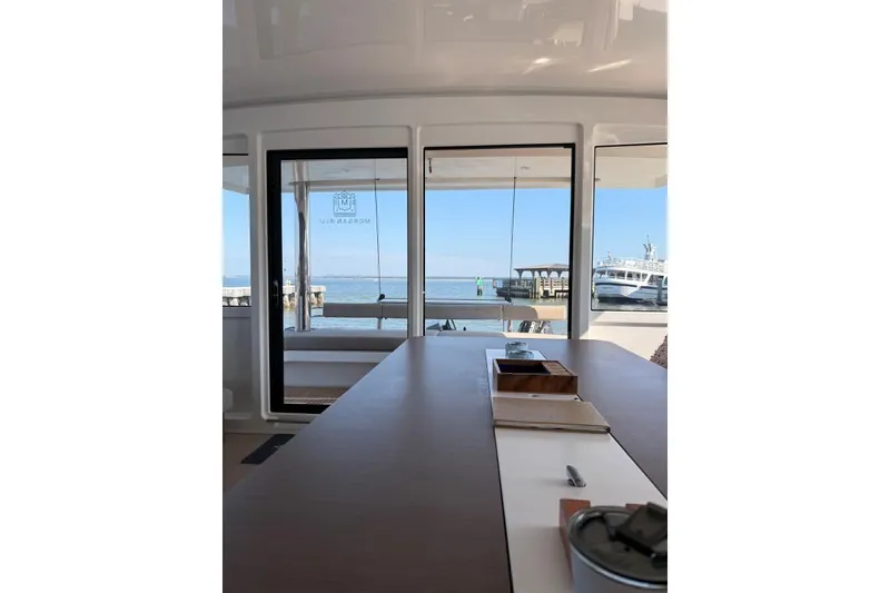 Slide: The Image of Interior view of 2021 Bali 5.4 yacht with ocean and dock in background. - 5