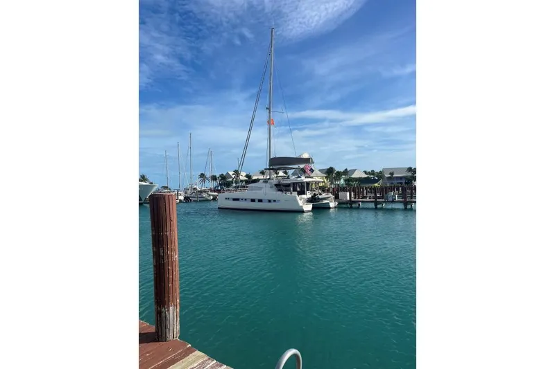 Slide: The Image of Sailboat Bali 5.4 (2021) docked in a sunny marina with clear blue skies. - 8