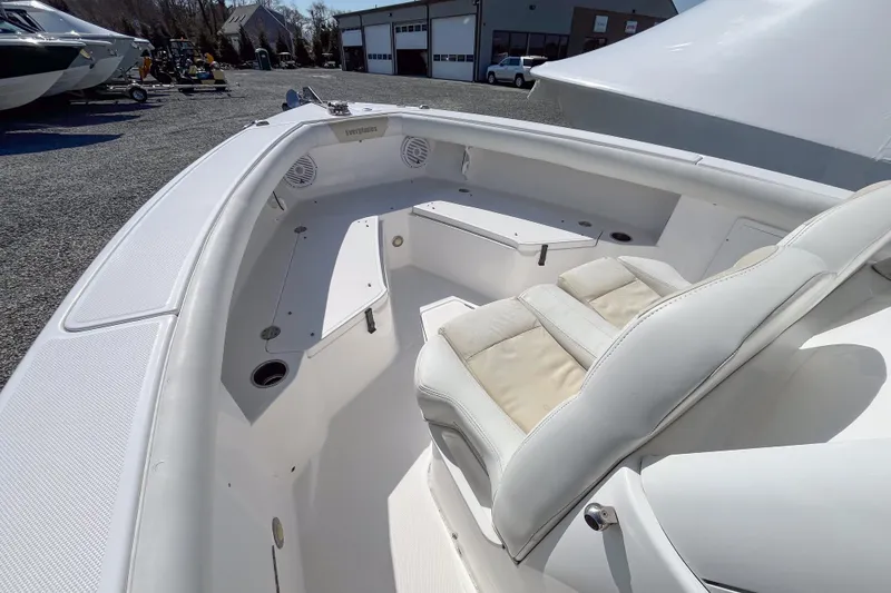 Slide: The Image of 2016 Everglades 255 Center Console boat interior with white seating and storage compartments. - 10