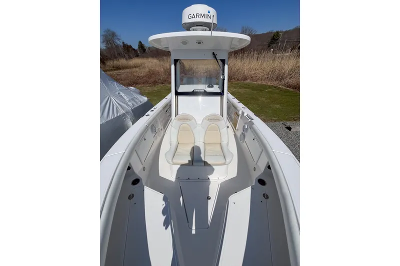 Slide: The Image of 2016 Everglades 255 Center Console boat with Garmin equipment, docked outdoors. - 16