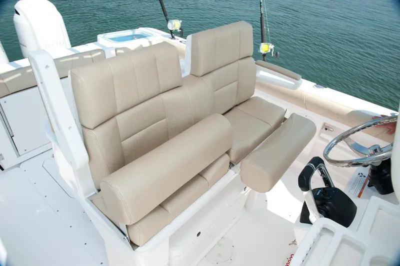 Slide: The Image of Manufacturer Provided Image: 2016 Everglades 255 Center Console boat with beige cushioned seating and fishing rod holders. - 7