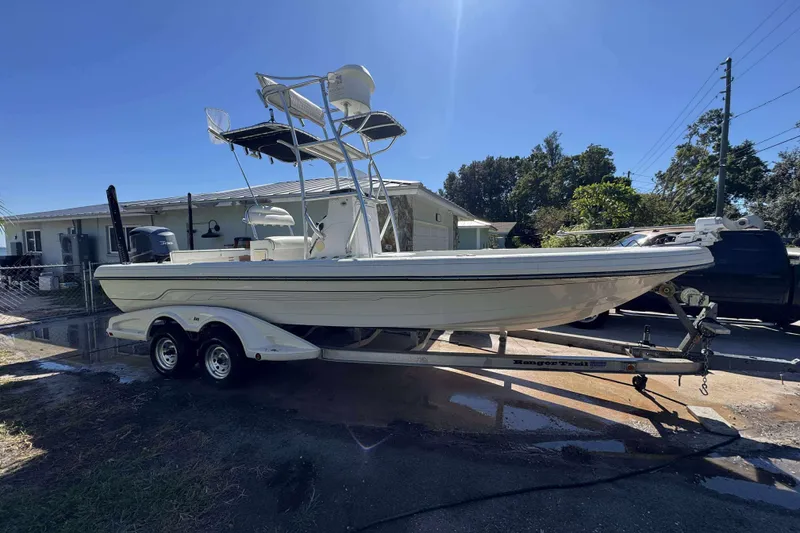 The Image of 2012 Ranger 2410 Bay Ranger boat on trailer, parked outdoors under clear sky. - 0