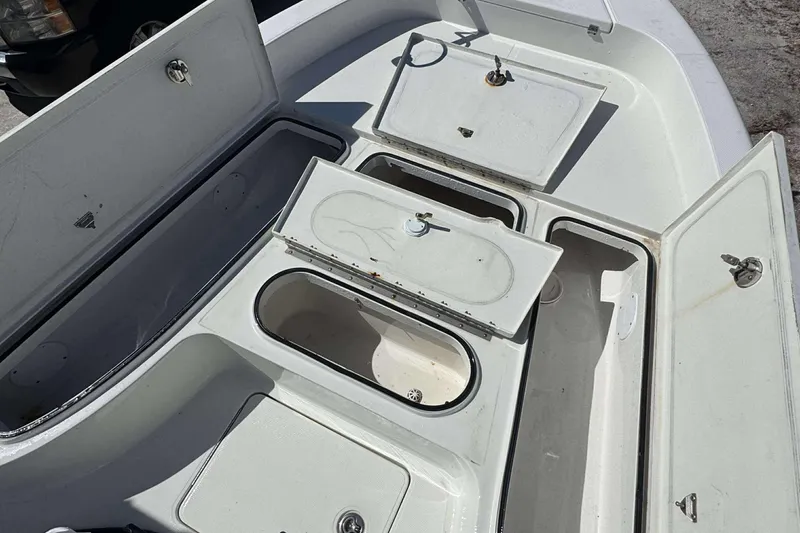 Slide: The Image of 2012 Ranger 2410 Bay Ranger boat storage compartments open, showcasing interior space. - 11