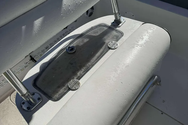 Slide: The Image of 2012 Ranger 2410 Bay Ranger boat seat with storage compartment, wet surface. - 19
