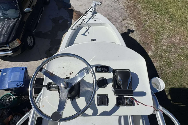 Slide: The Image of 2012 Ranger 2410 Bay Ranger boat helm with steering wheel and controls. - 2