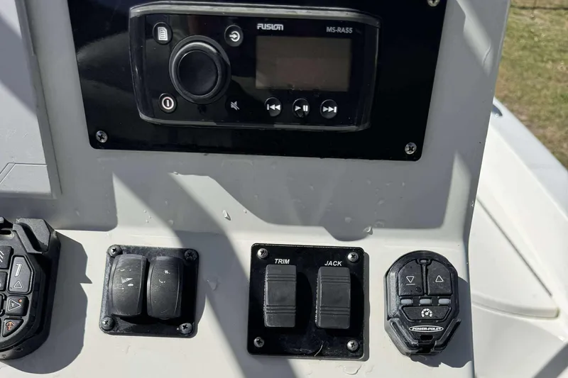 Slide: The Image of Control panel of a 2012 Ranger 2410 Bay Ranger boat with various switches and buttons. - 21