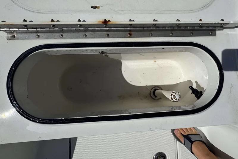 Slide: The Image of Open storage compartment on 2012 Ranger 2410 Bay Ranger boat deck. - 22