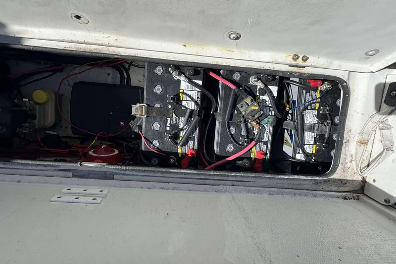 Slide: The Image of Battery compartment of a 2012 Ranger 2410 Bay Ranger boat with wiring and components. - 25