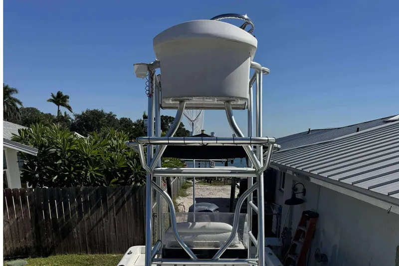 Slide: The Image of 2012 Ranger 2410 Bay Ranger boat with elevated tower against clear blue sky. - 3