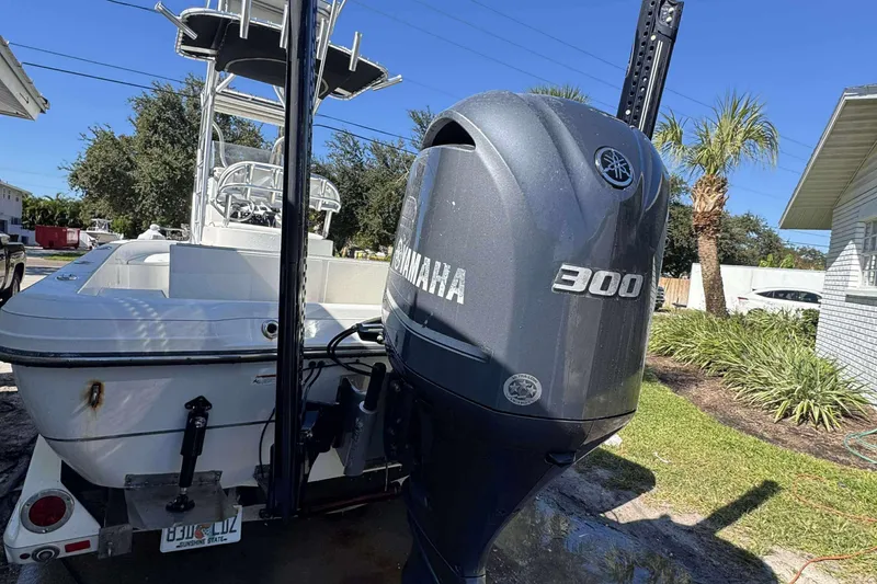 Slide: The Image of 2012 Ranger 2410 Bay Ranger boat with Yamaha 300 outboard motor in a sunny yard. - 4