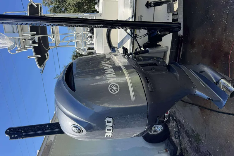 Slide: The Image of 2012 Ranger 2410 Bay Ranger with Yamaha 300 outboard motor, parked outdoors. - 5