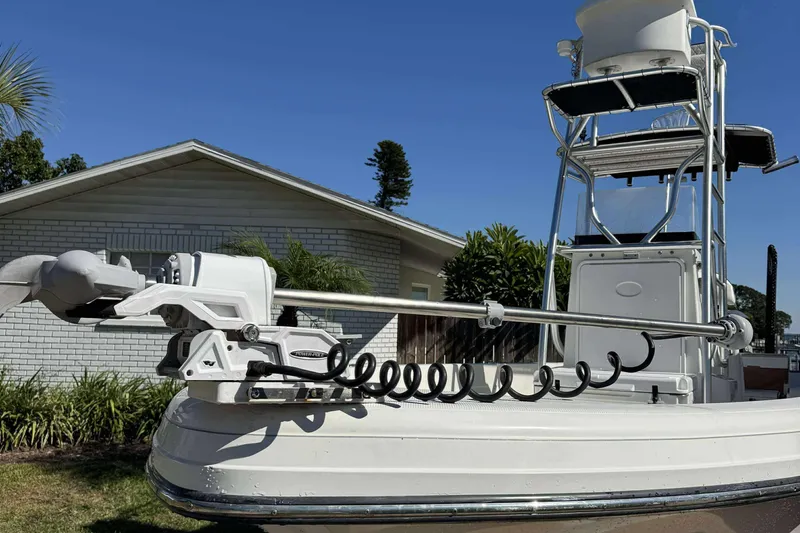 Slide: The Image of 2012 Ranger 2410 Bay Ranger boat with trolling motor, docked near a house. - 6