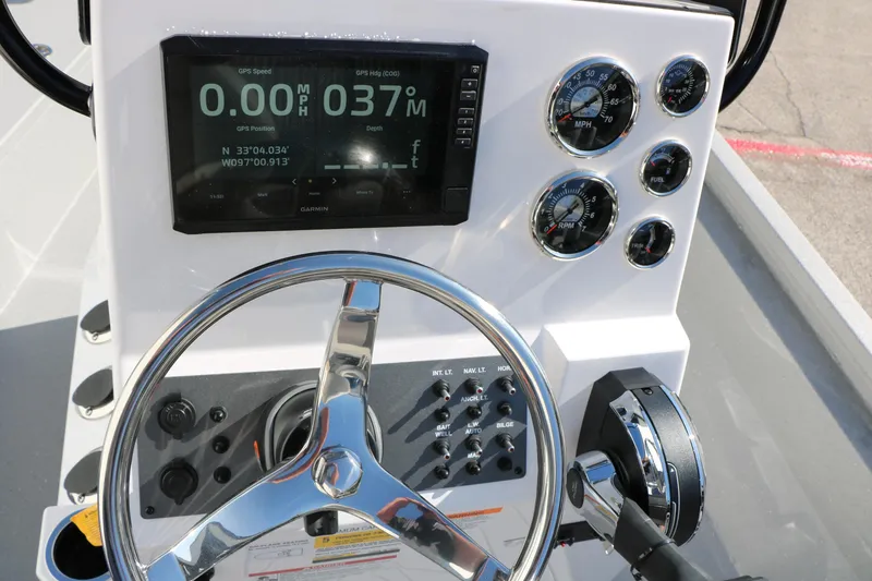 Slide: The Image of 2026 Vexus ACX2000 boat dashboard with GPS, gauges, and steering wheel. - 18