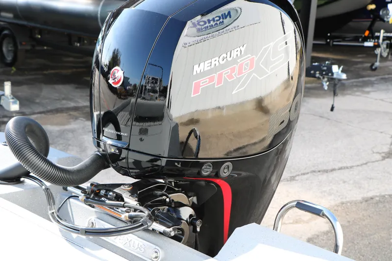 Slide: The Image of 2026 Vexus ACX2000 with Mercury Pro XS outboard motor in a boatyard setting. - 29
