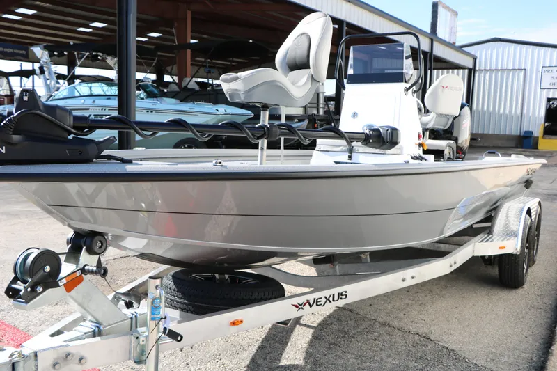 Slide: The Image of 2026 Vexus ACX2000 boat on trailer, displayed outdoors at a marina. - 6