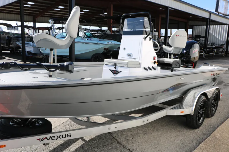 Slide: The Image of 2026 Vexus ACX2000 boat on trailer, sleek design, parked in marina. - 7