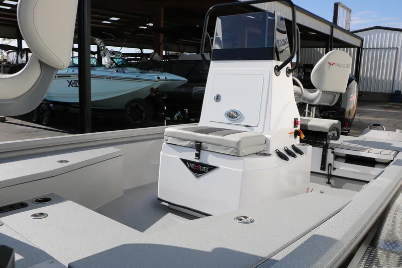 Slide: The Image of 2026 Vexus ACX2000 boat interior with console and seating in a showroom. - 8