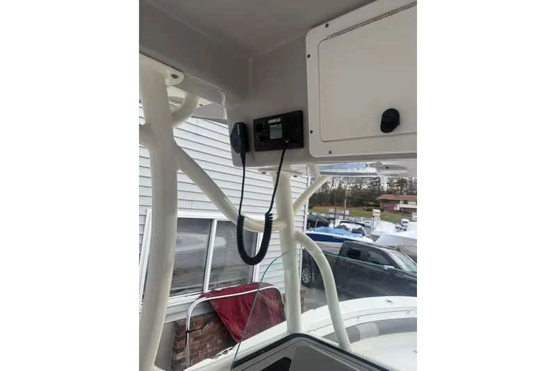 Slide: The Image of 2023 Sea Born LX22 Center Console interior with radio and storage compartment. - 12