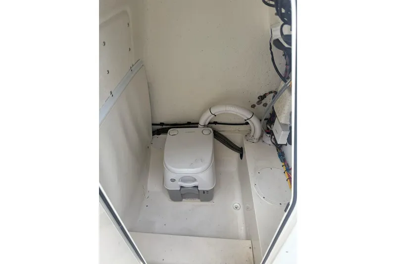 Slide: The Image of 2023 Sea Born LX22 Center Console boat interior with compact marine toilet. - 13