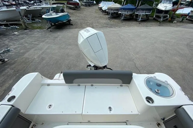 Slide: The Image of 2023 Sea Born LX22 Center Console boat with outboard motor, docked in a marina. - 8