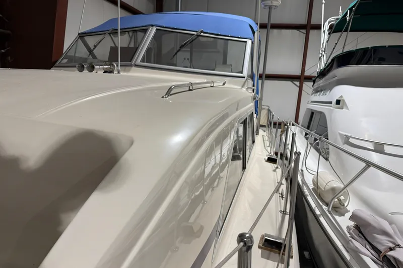 Slide: The Image of 1979 Chris-Craft 350 Catalina yacht with blue canopy, docked indoors. - 15