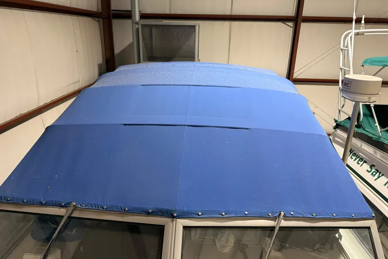 Slide: The Image of 1979 Chris-Craft 350 Catalina with blue canvas cover in storage. - 2