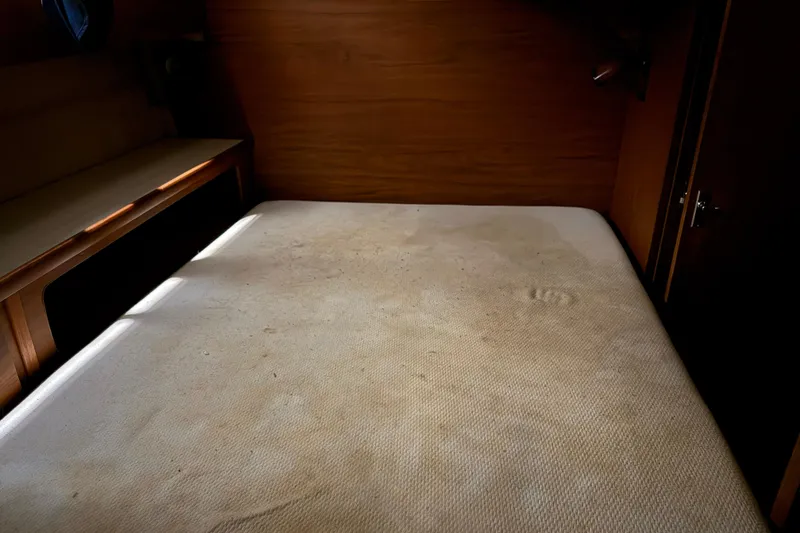 Slide: The Image of Interior cabin of 1979 Chris-Craft 350 Catalina with a bed and wooden paneling. - 20